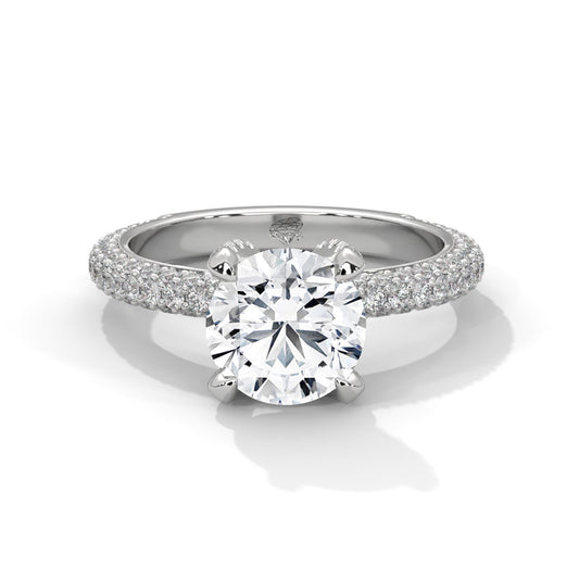 A round brilliant cut diamond ring with a triple row pavé band, displayed on a white background.