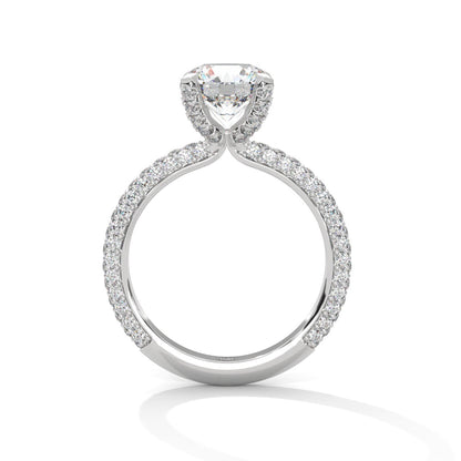 a diamond ring with three way pave band on a plain background