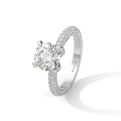 a diamond ring with three way pave band on a plain background