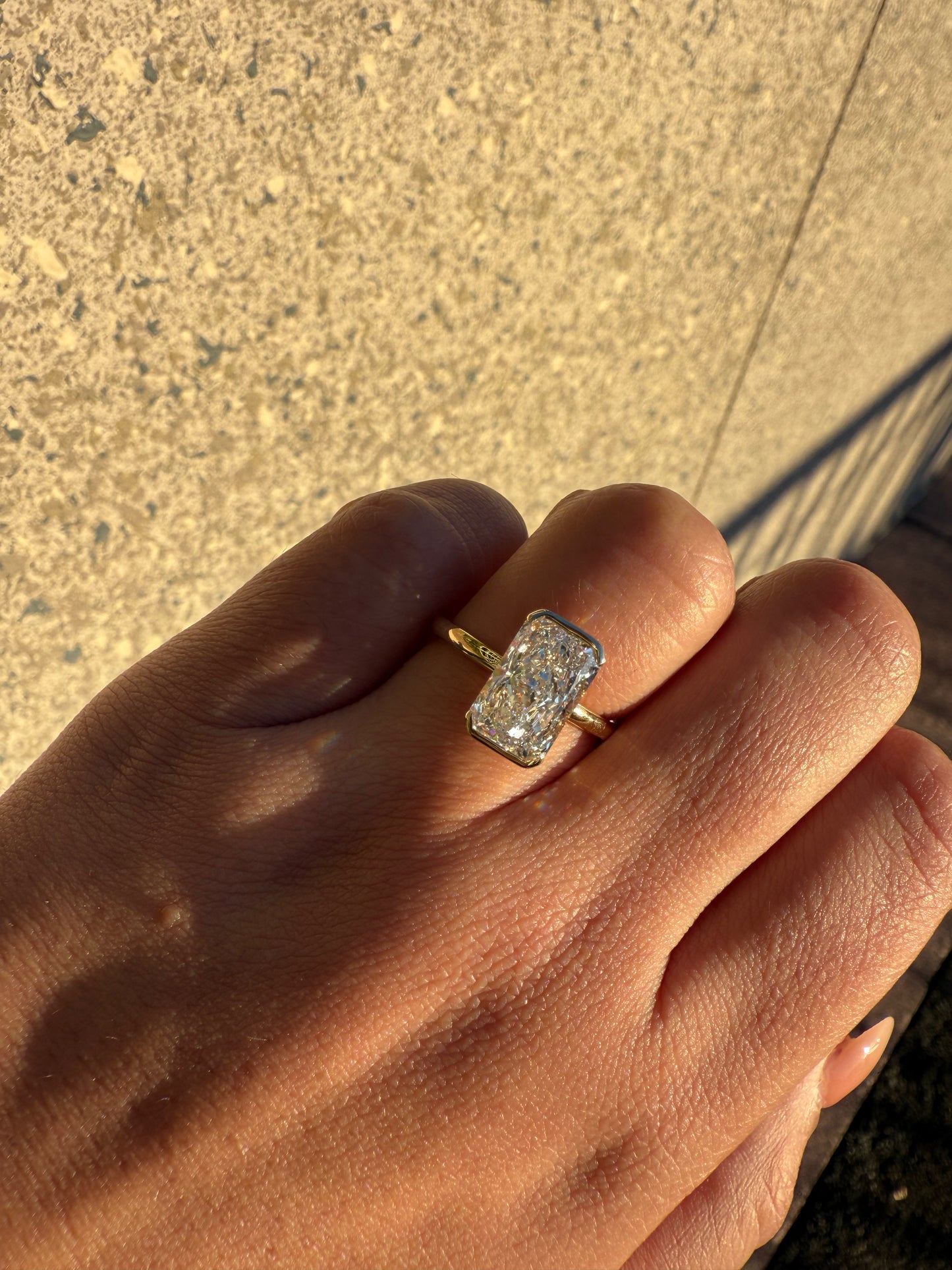 Amira- Radiant cut centre stone in a Half Bezel setting