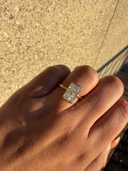 Amira- Radiant cut centre stone in a Half Bezel setting