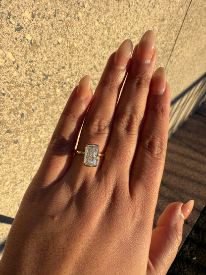 Amira- Radiant cut centre stone in a Half Bezel setting