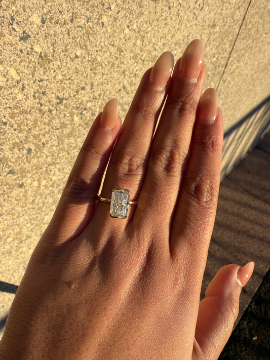 Amira- Radiant cut centre stone in a Half Bezel setting