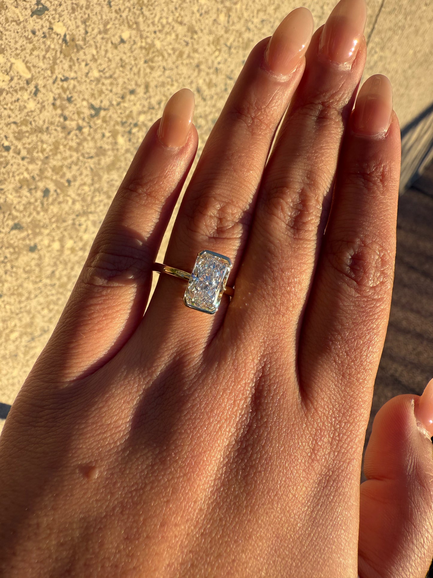 Amira- Radiant cut centre stone in a Half Bezel setting