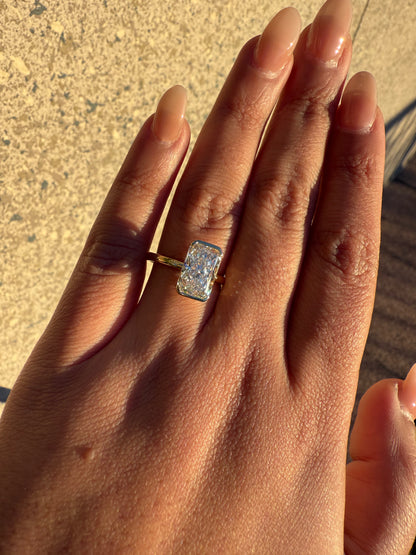 Amira- Radiant cut centre stone in a Half Bezel setting