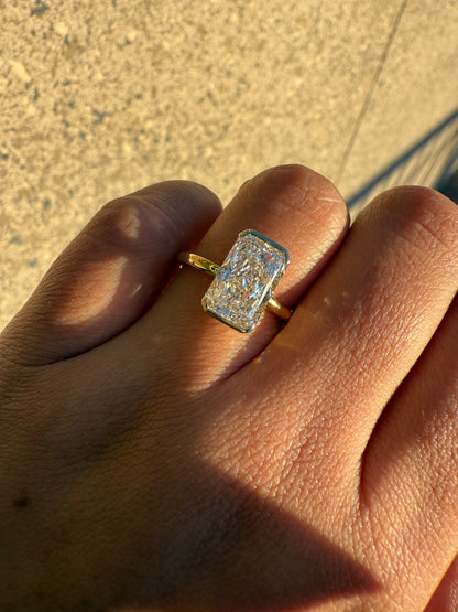 Amira- Radiant cut centre stone in a Half Bezel setting
