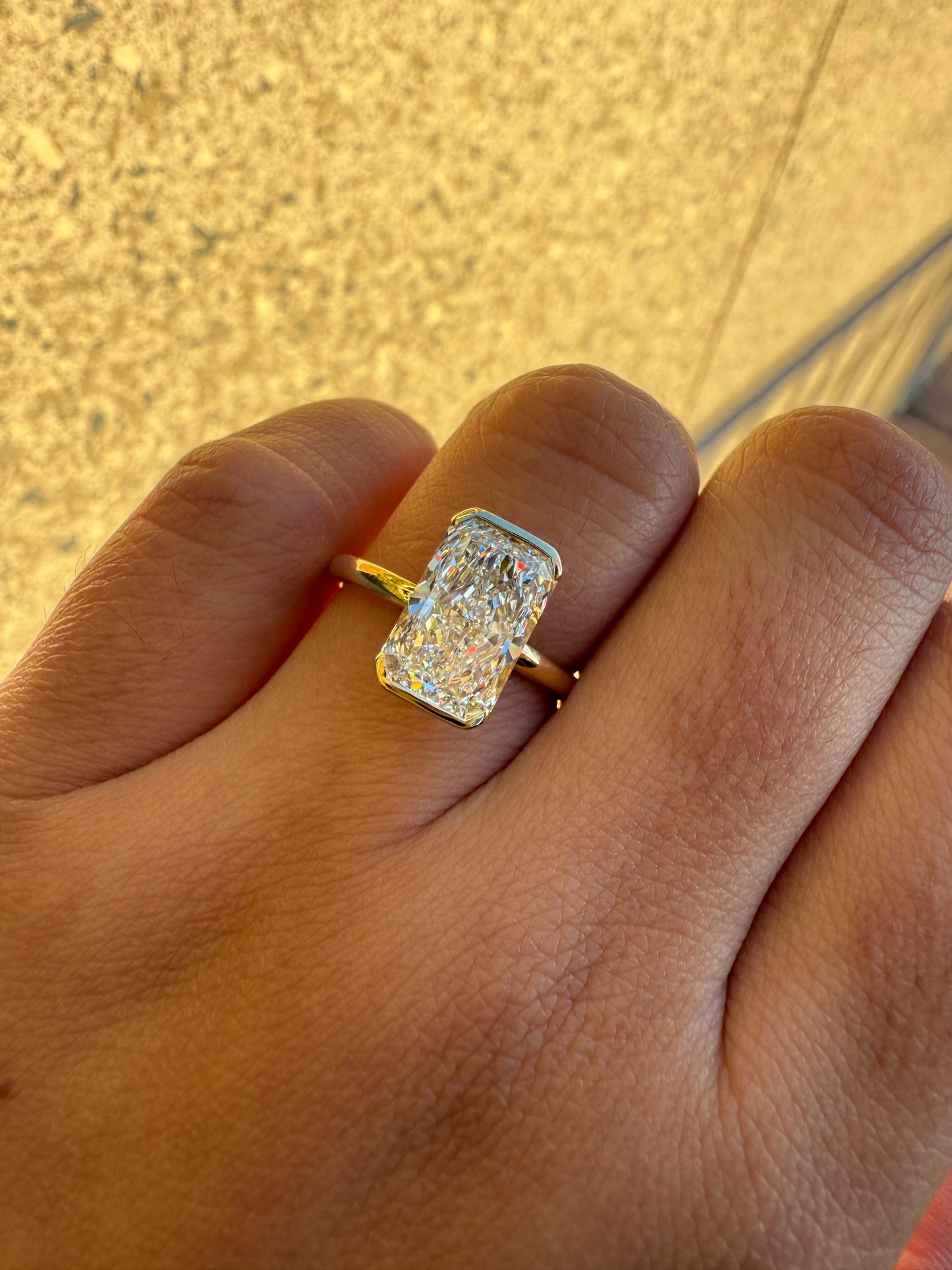 Amira- Radiant cut centre stone in a Half Bezel setting
