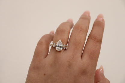 Hand wearing a diamond ring on a plain background