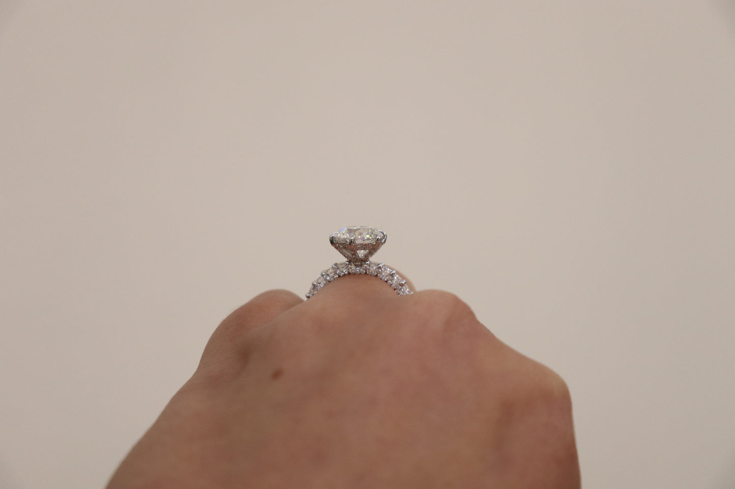 Round Brilliant cut ring with a pavè band on a hand