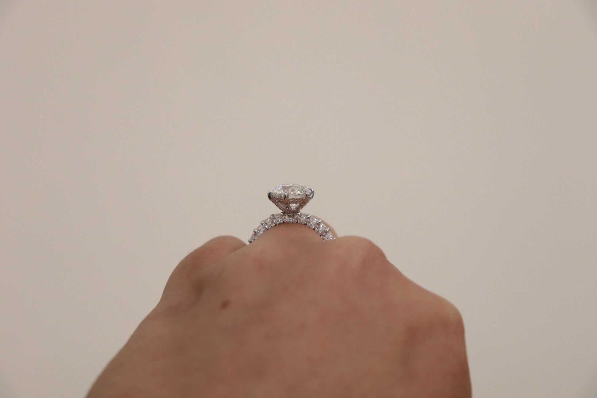 Round Brilliant cut ring with a pavè band on a hand