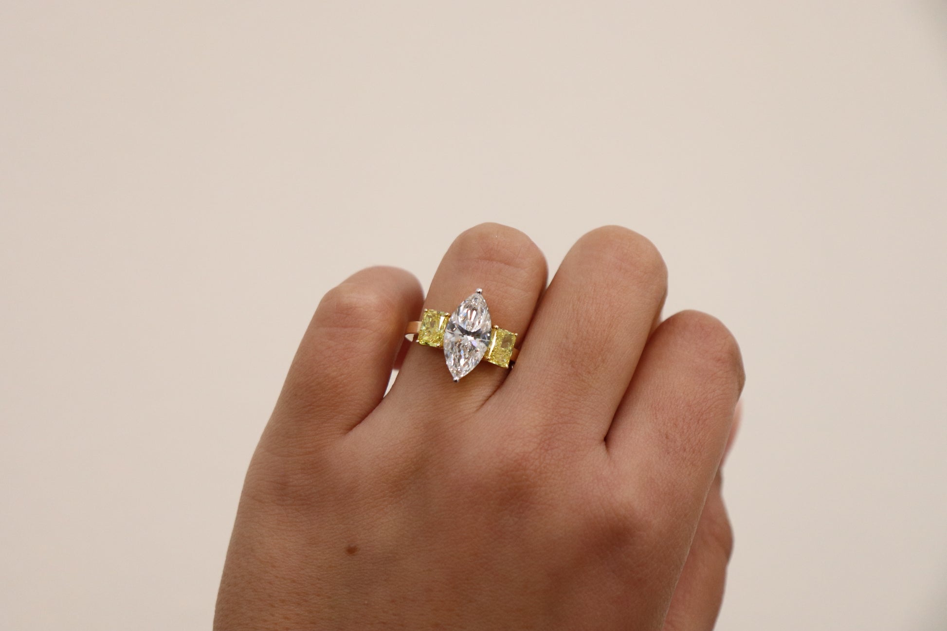 Marquise ring in Trilogy Style with vivd yellow radiants on the side