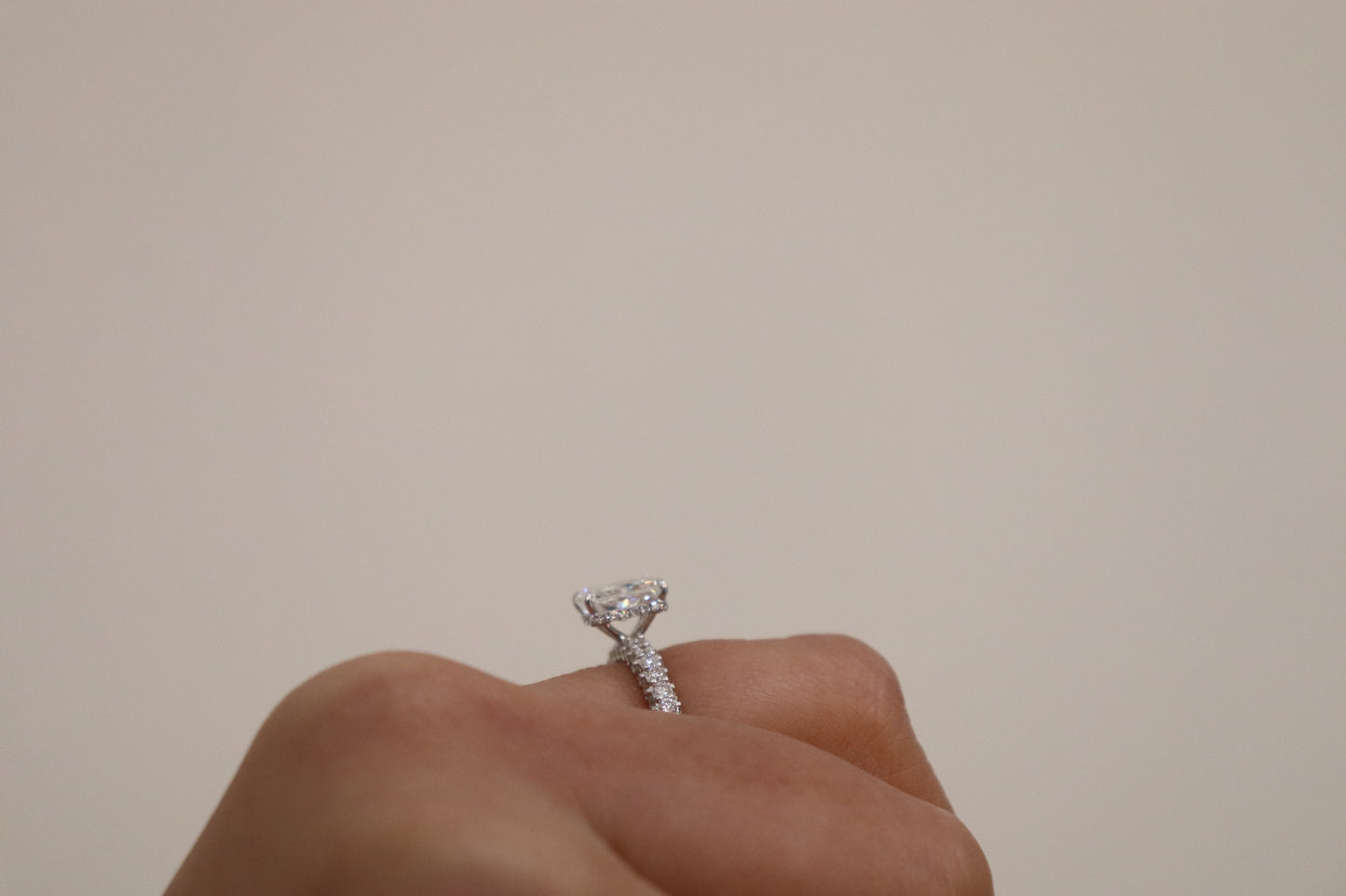 hand wearing a radiant cut diamond ring 