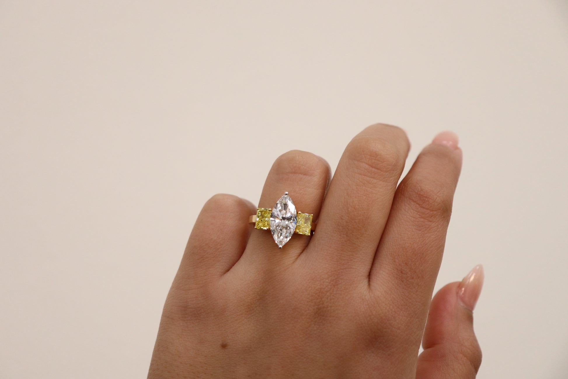 Marquise ring in Trilogy Style with vivd yellow radiants on the side